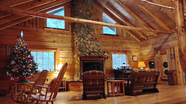 N4774 11th Dr, Montello, WI 53949 - living area with wood finished floors, beamed ceiling, wooden walls, a fireplace, and high vaulted ceiling