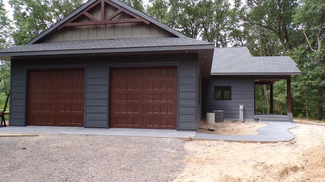1644 Kingswood Trl, Nekoosa, WI 54457 - view of front of home with a shingled roof, board and batten siding, and a detached garage