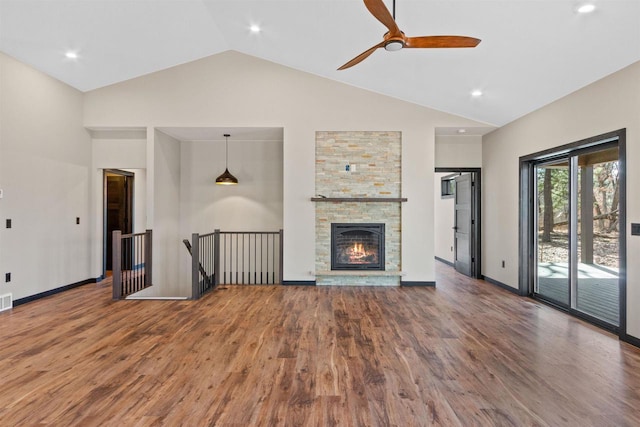 1644 Kingswood Trl, Nekoosa, WI 54457 - unfurnished living room with high vaulted ceiling, wood finished floors, a ceiling fan, a fireplace, and baseboards
