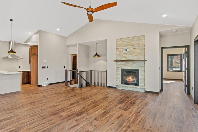 1644 Kingswood Trl, Nekoosa, WI 54457 - unfurnished living room with ceiling fan, light wood finished floors, high vaulted ceiling, a fireplace, and baseboards