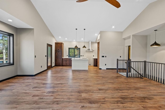 1644 Kingswood Trl, Nekoosa, WI 54457 - unfurnished living room with wood finished floors, ceiling fan, baseboards, high vaulted ceiling, and recessed lighting