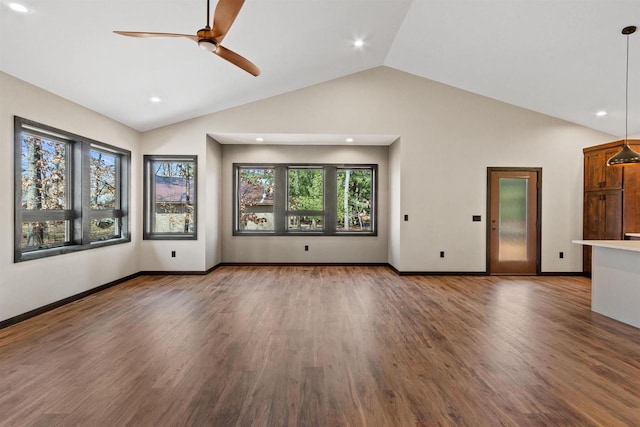 1644 Kingswood Trl, Nekoosa, WI 54457 - unfurnished living room with vaulted ceiling, a ceiling fan, plenty of natural light, wood finished floors, and baseboards