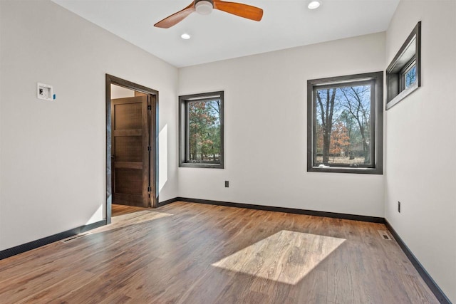 1644 Kingswood Trl, Nekoosa, WI 54457 - unfurnished room with plenty of natural light, wood finished floors, baseboards, and recessed lighting