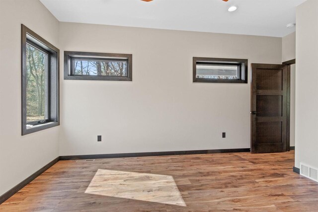 1644 Kingswood Trl, Nekoosa, WI 54457 - spare room featuring wood finished floors, baseboards, a smoke detector, and recessed lighting