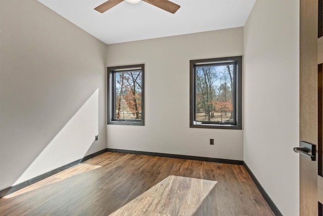 1644 Kingswood Trl, Nekoosa, WI 54457 - unfurnished room featuring wood finished floors, a ceiling fan, and baseboards