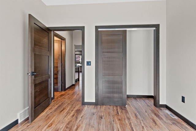 1644 Kingswood Trl, Nekoosa, WI 54457 - unfurnished bedroom with wood finished floors and baseboards