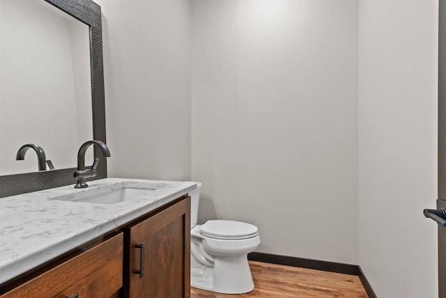 1644 Kingswood Trl, Nekoosa, WI 54457 - bathroom featuring wood finished floors, toilet, vanity, and baseboards
