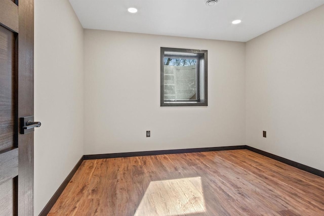 1644 Kingswood Trl, Nekoosa, WI 54457 - unfurnished room featuring wood finished floors, baseboards, and recessed lighting