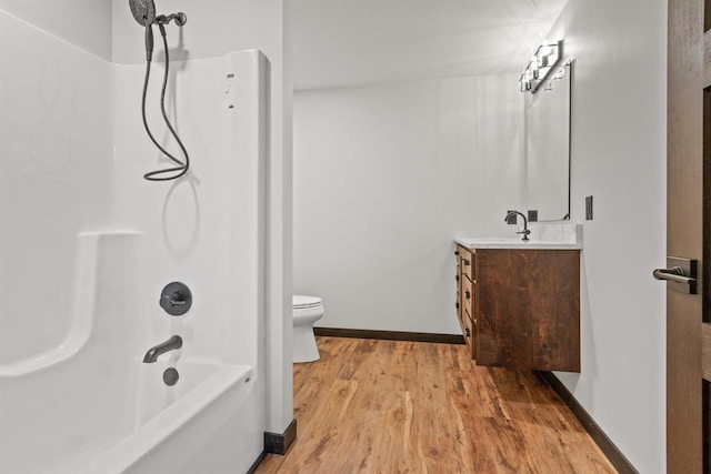 1644 Kingswood Trl, Nekoosa, WI 54457 - bathroom featuring toilet, vanity, wood finished floors, and bathing tub / shower combination
