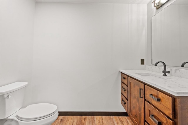 1644 Kingswood Trl, Nekoosa, WI 54457 - half bathroom with wood finished floors, baseboards, vanity, and toilet