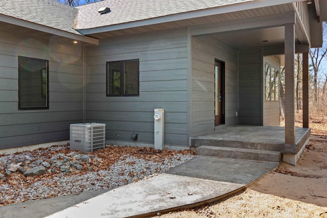 1644 Kingswood Trl, Nekoosa, WI 54457 - view of exterior entry with roof with shingles and central AC