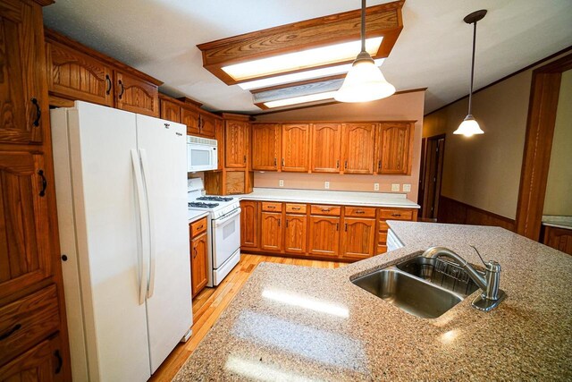 N7957 15th Ave, New Lisbon, WI 53950 - kitchen featuring light wood finished floors, pendant lighting, brown cabinets, white appliances, and a sink