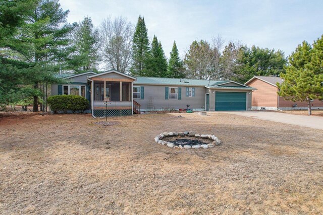 N7957 15th Ave, New Lisbon, WI 53950 - ranch-style house with a sunroom, an attached garage, and driveway