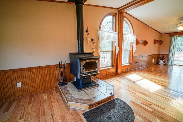 N7957 15th Ave, New Lisbon, WI 53950 - living area featuring wood finished floors, wood walls, crown molding, wainscoting, and a wood stove