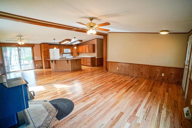 N7957 15th Ave, New Lisbon, WI 53950 - unfurnished living room with wooden walls, wainscoting, light wood-style flooring, and ceiling fan