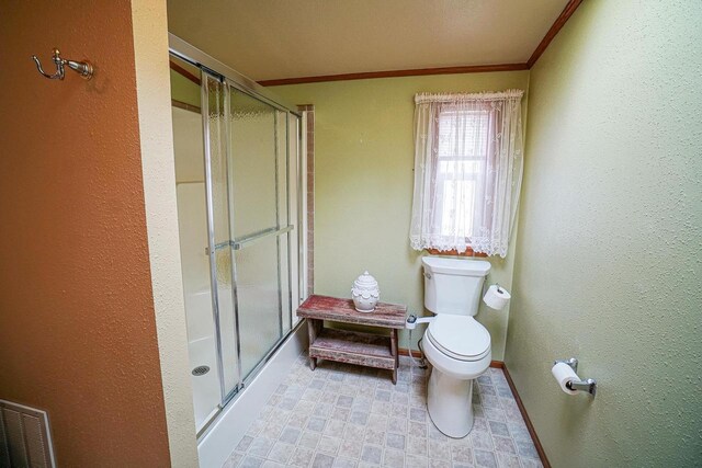 N7957 15th Ave, New Lisbon, WI 53950 - full bathroom featuring baseboards, toilet, ornamental molding, and a shower stall