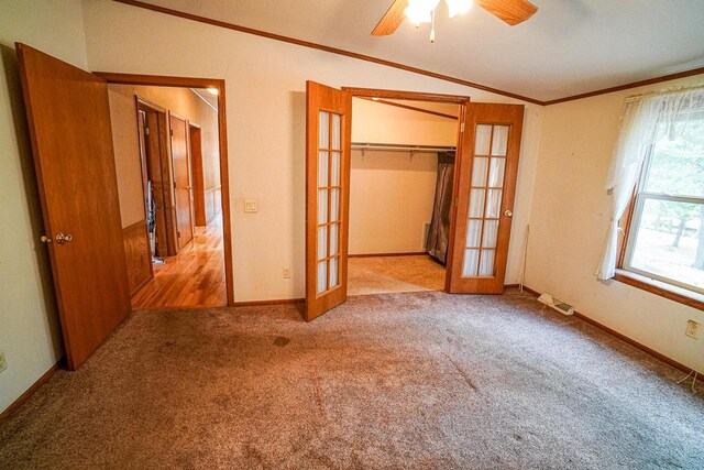 N7957 15th Ave, New Lisbon, WI 53950 - unfurnished bedroom featuring lofted ceiling, french doors, carpet floors, crown molding, and baseboards