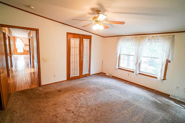 N7957 15th Ave, New Lisbon, WI 53950 - empty room with visible vents, baseboards, carpet, ceiling fan, and ornamental molding
