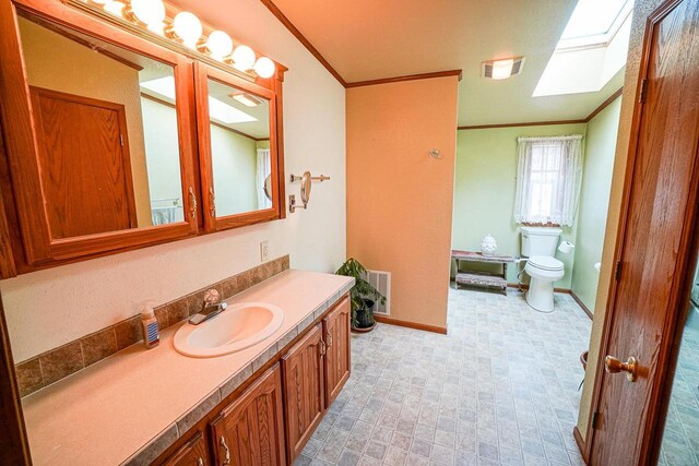 N7957 15th Ave, New Lisbon, WI 53950 - bathroom with vanity, baseboards, visible vents, ornamental molding, and toilet
