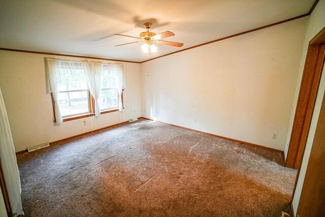 N7957 15th Ave, New Lisbon, WI 53950 - carpeted spare room featuring visible vents, baseboards, crown molding, and a ceiling fan