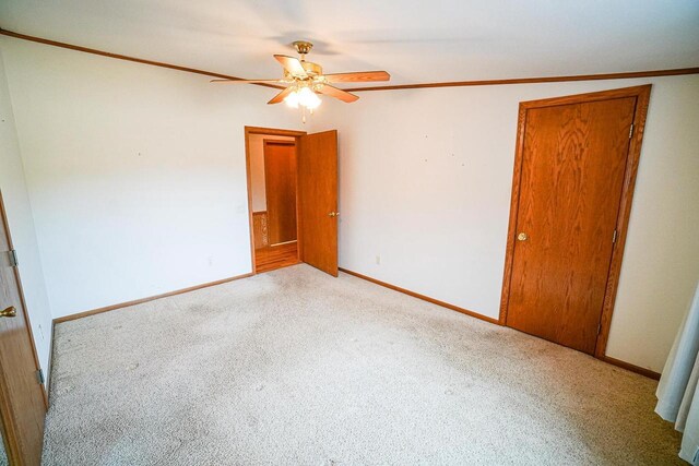 N7957 15th Ave, New Lisbon, WI 53950 - empty room featuring ceiling fan, baseboards, carpet, and ornamental molding