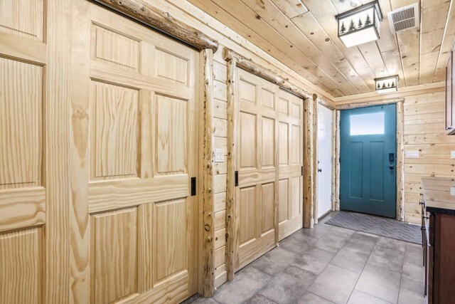 10728 Spring St, Mount Pleasant, WI 53177 - doorway with wooden walls, wood ceiling, and visible vents