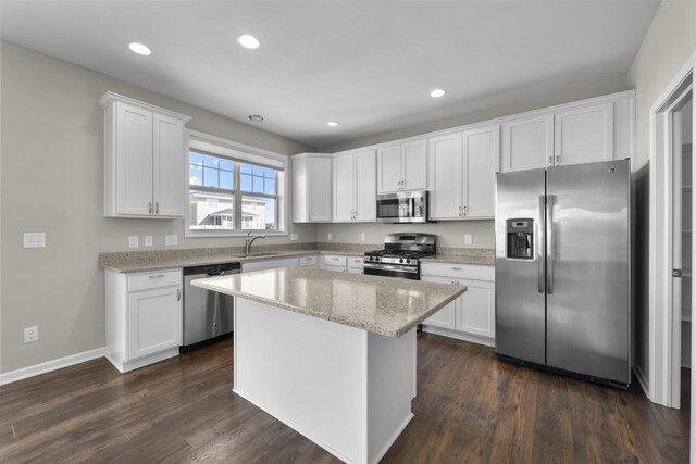 kitchen featuring a center island, recessed lighting, stainless steel appliances, white cabinets, and dark wood-style flooring