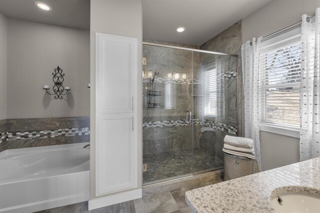 301 Church St, Barneveld, WI 53507 - bathroom featuring a bath, recessed lighting, a stall shower, and vanity