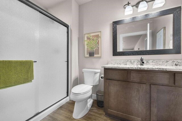301 Church St, Barneveld, WI 53507 - full bathroom with vanity, toilet, wood finished floors, and a shower stall
