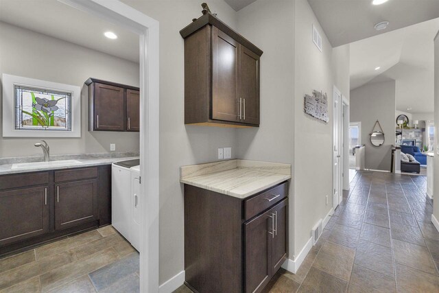 301 Church St, Barneveld, WI 53507 - kitchen with visible vents, a sink, recessed lighting, light countertops, and dark brown cabinets