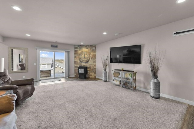 301 Church St, Barneveld, WI 53507 - living room with recessed lighting, carpet flooring, baseboards, and a wood stove
