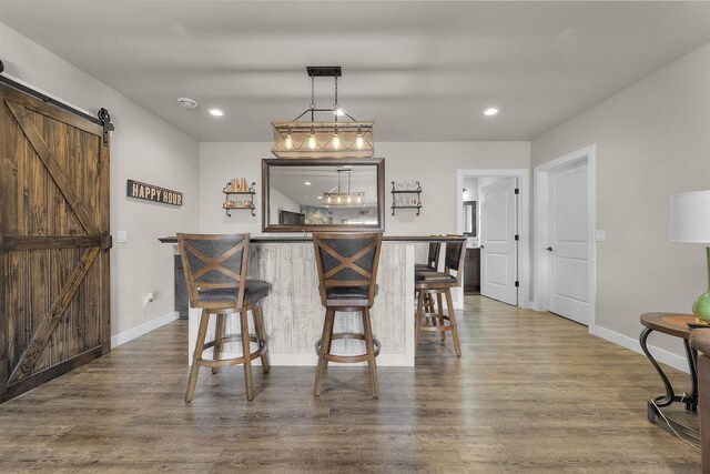 301 Church St, Barneveld, WI 53507 - dining space featuring dark wood finished floors, recessed lighting, baseboards, and a barn door