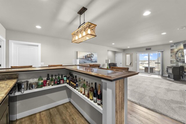 301 Church St, Barneveld, WI 53507 - kitchen with wood finished floors, baseboards, recessed lighting, hanging light fixtures, and open floor plan