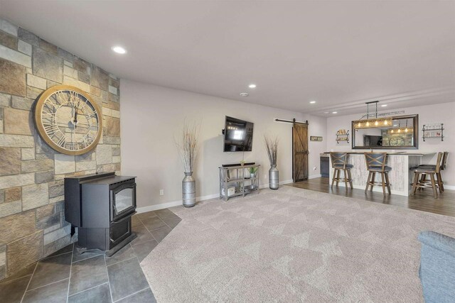 301 Church St, Barneveld, WI 53507 - living room featuring recessed lighting, a barn door, baseboards, and a wood stove
