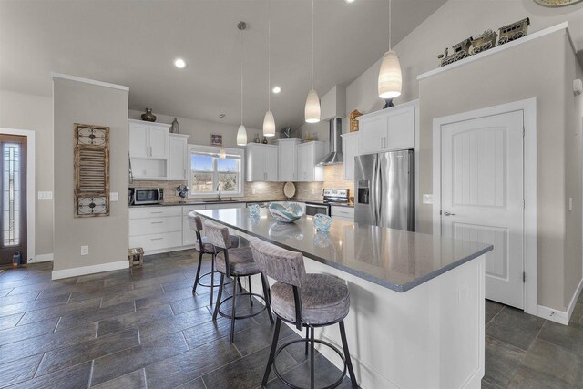 301 Church St, Barneveld, WI 53507 - kitchen with wall chimney exhaust hood, tasteful backsplash, appliances with stainless steel finishes, and a sink
