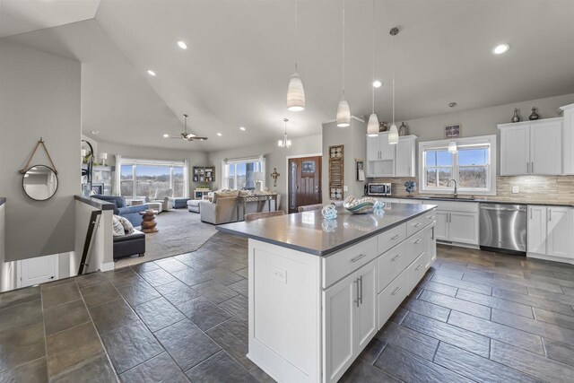 301 Church St, Barneveld, WI 53507 - kitchen featuring a sink, a kitchen island, open floor plan, appliances with stainless steel finishes, and decorative backsplash