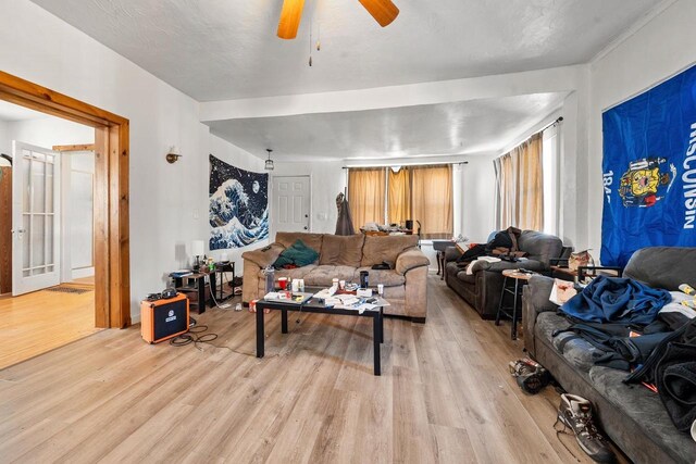 living room featuring a ceiling fan and light wood finished floors