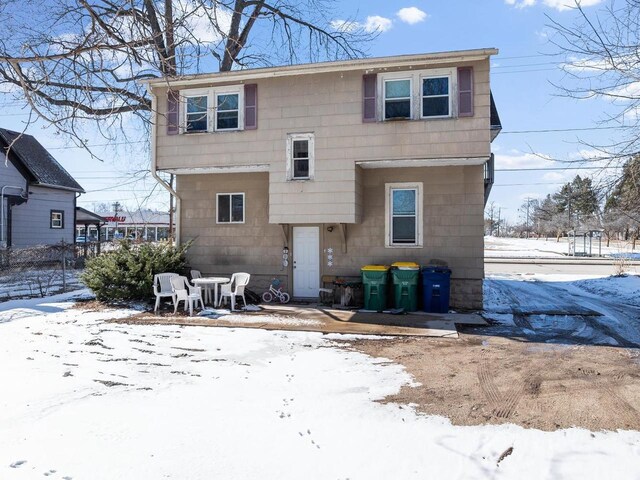 view of snow covered rear of property