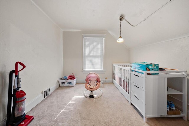 carpeted bedroom with visible vents, lofted ceiling, and ornamental molding