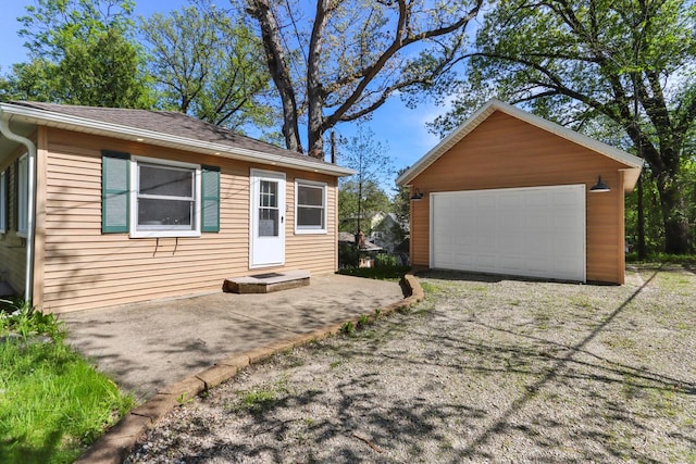 44 Oakwood St, Williams Bay, WI 53191 - view of front facade featuring an outbuilding, a detached garage, and roof with shingles