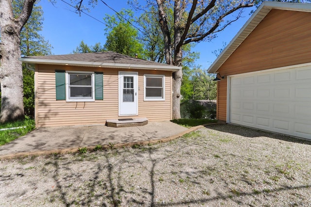 44 Oakwood St, Williams Bay, WI 53191 - rear view of house with a garage, an outbuilding, and a shingled roof