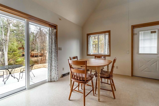1735 W 19th Ave, Arkdale, WI 54613 - dining space with visible vents, light floors, and lofted ceiling
