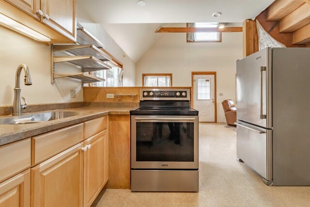 1735 W 19th Ave, Arkdale, WI 54613 - kitchen with light floors, light brown cabinets, lofted ceiling, a sink, and appliances with stainless steel finishes
