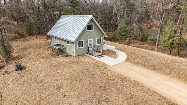 1735 W 19th Ave, Arkdale, WI 54613 - exterior space featuring a wooded view, metal roof, and dirt driveway