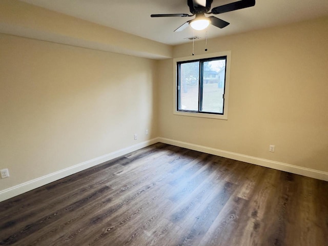 unfurnished room featuring visible vents, ceiling fan, baseboards, and dark wood-style flooring
