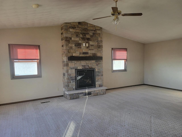 W11829 Buss Ln, Waterloo, WI 53594 - unfurnished living room featuring vaulted ceiling, carpet floors, a ceiling fan, and a stone fireplace
