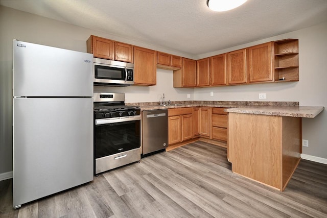 458 High Forest St, Winona, MN 55987 - kitchen featuring open shelves, light wood-style flooring, a peninsula, and stainless steel appliances