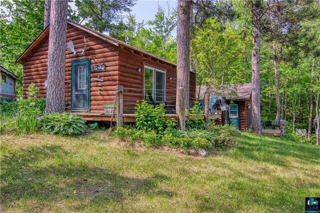 9293 N County Hwy E, Hayward, WI 54843 - exterior space with log veneer siding and a yard