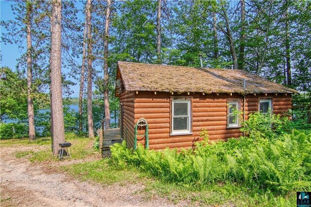 9293 N County Hwy E, Hayward, WI 54843 - view of side of property with faux log siding and an outbuilding