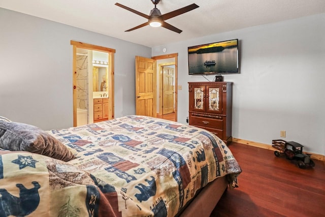 1055 Shishebogama Dr, Minocqua, WI 54548 - bedroom featuring wood finished floors, baseboards, ceiling fan, and ensuite bathroom
